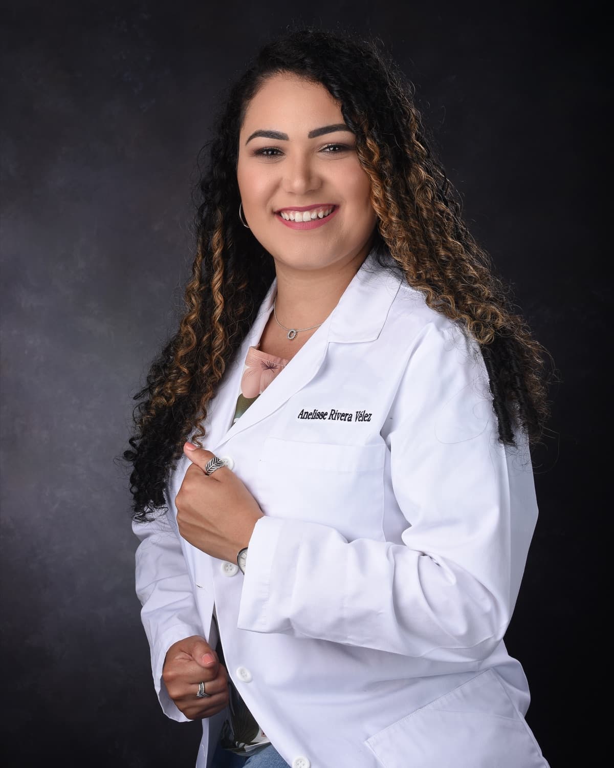 Dr. Anelisse Rivera, DMD, smiling in her white coat